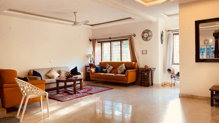 Spacious living room with stylish furniture and natural sunlight.
